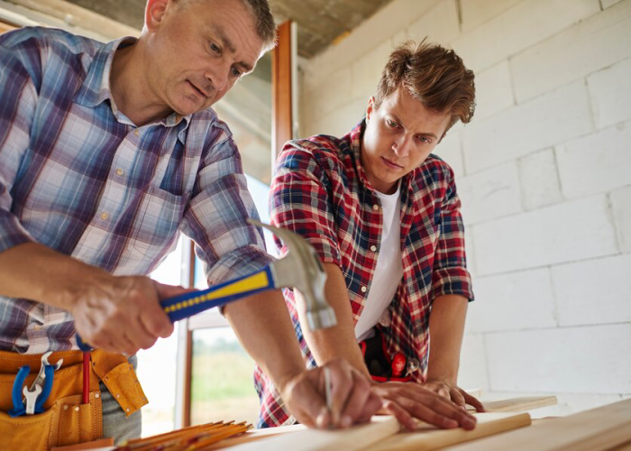 worker sticking nail into wooden plank 329181 15646 worker sticking nail into wooden plank 329181 15646